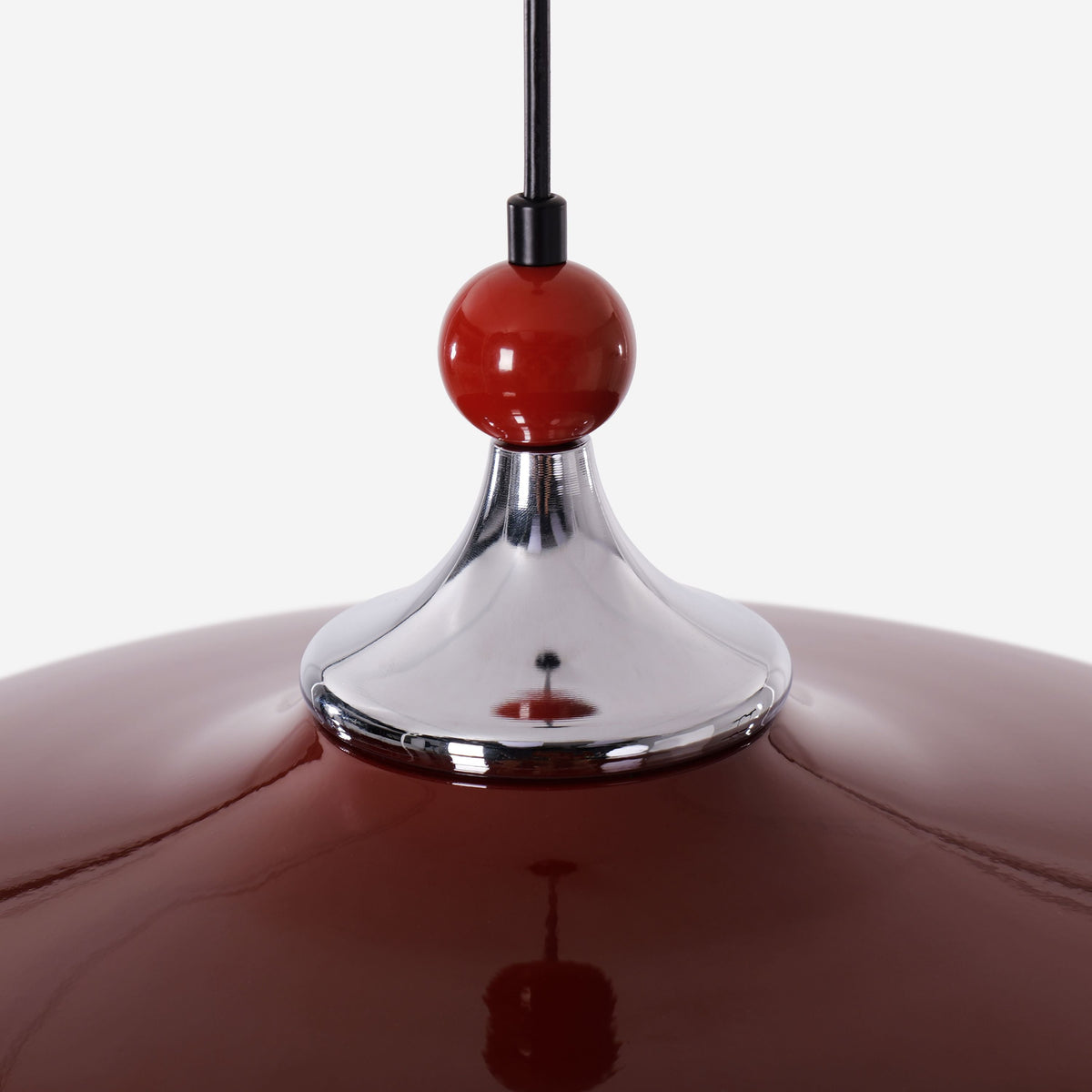 red iron pendant light beside a cosy seating area