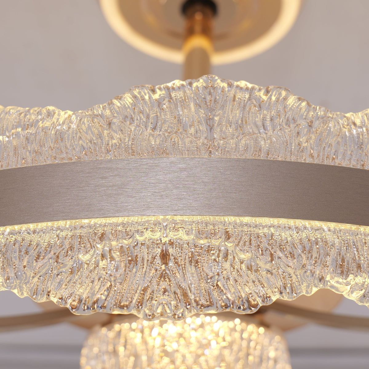 Close-up of gold crystal ceiling fan light with sparkling water ripple edge