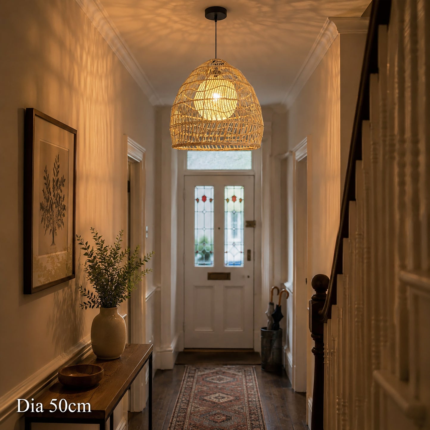 50cm rattan pendant light with yellow inner sphere glowing in a hallway