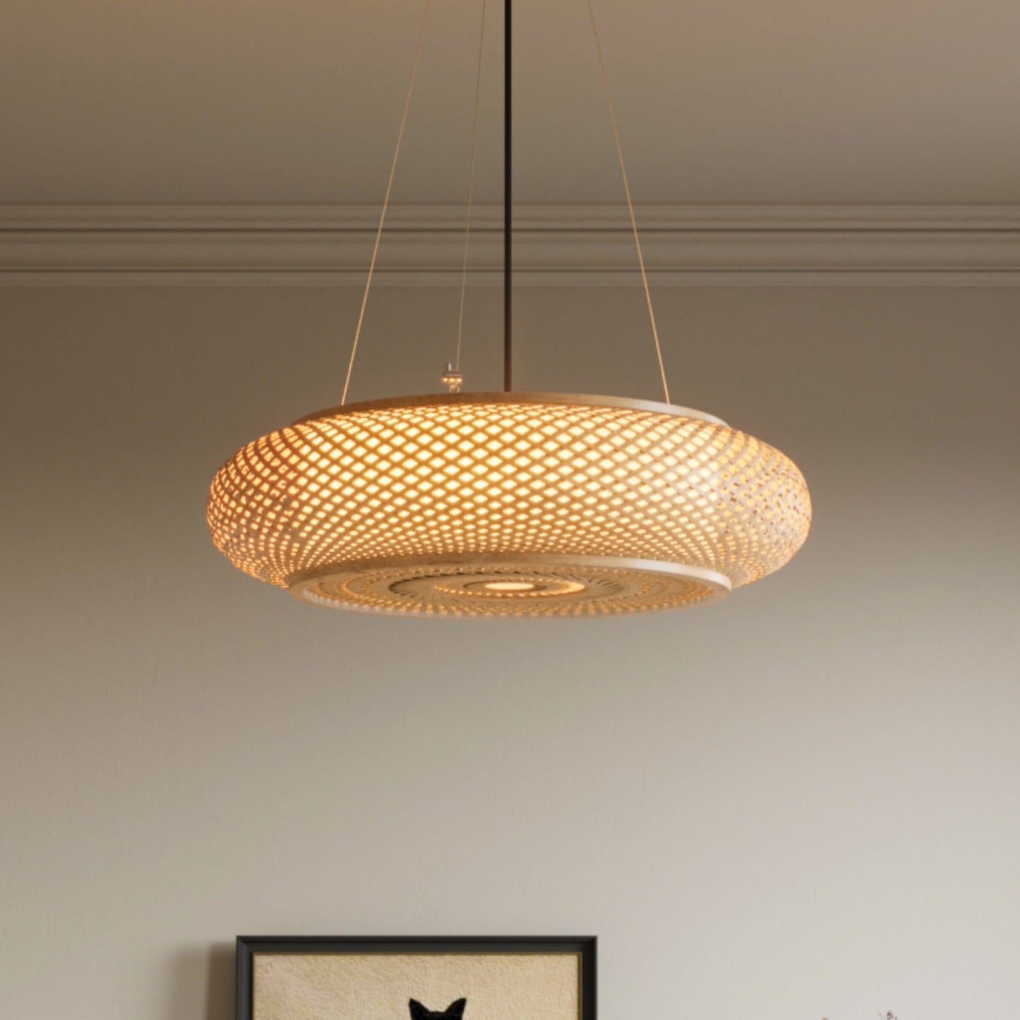 large bamboo pendant light glowing in a dining room