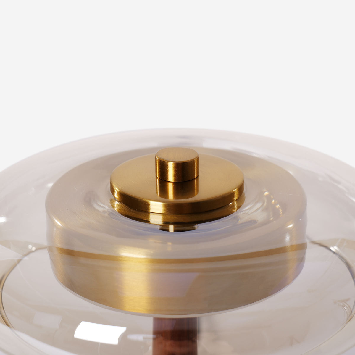 ash wood and glass table lamp beside books and evening decor