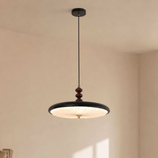 black pleated pendant light shown as a clean product view