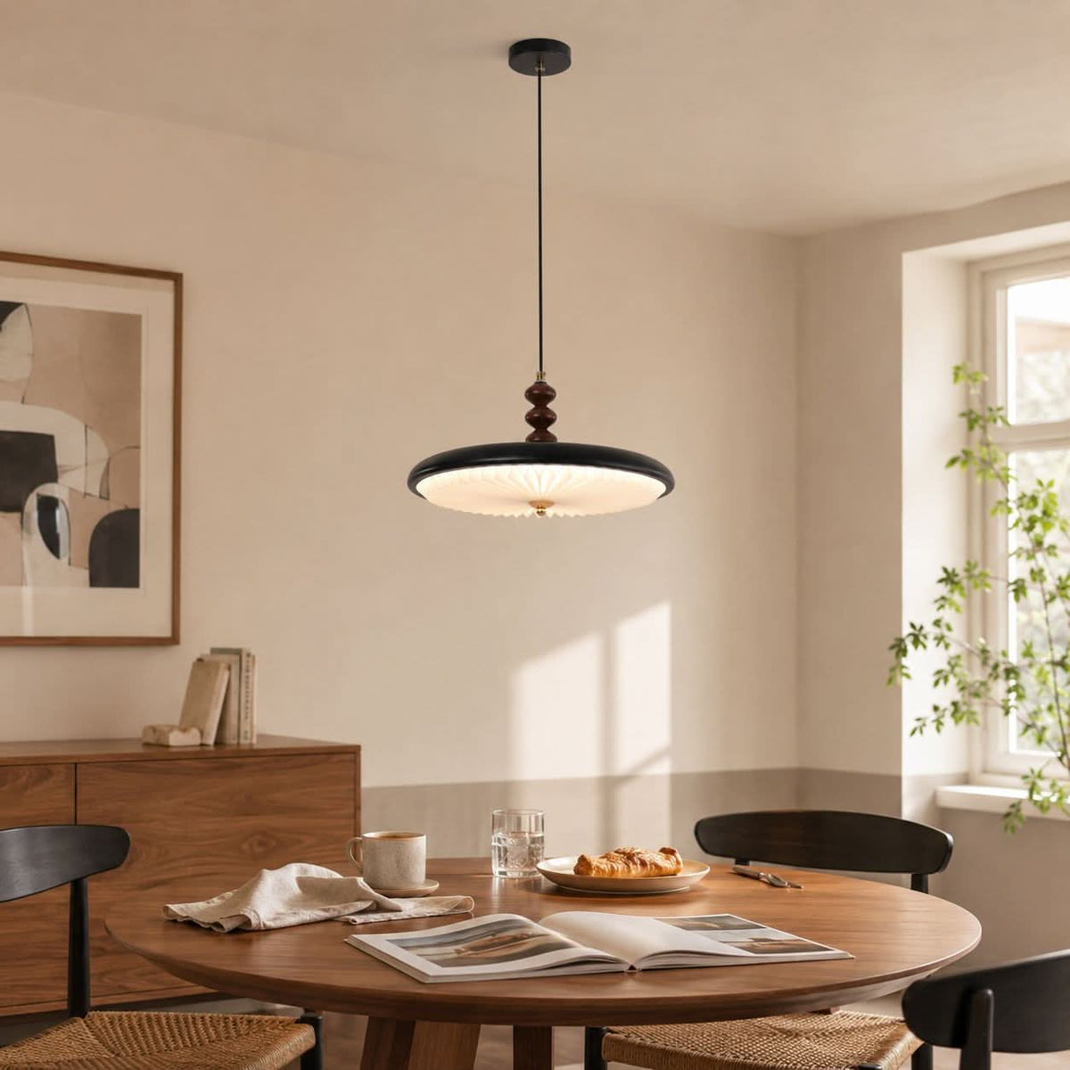 black pleated pendant light styled in a calm bedroom
