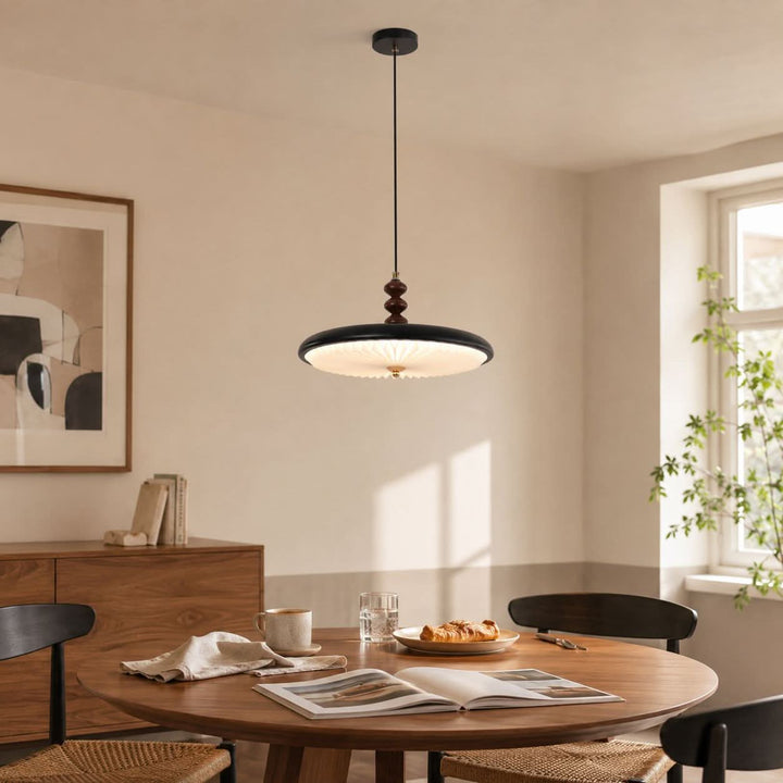 black pleated pendant light styled in a calm bedroom
