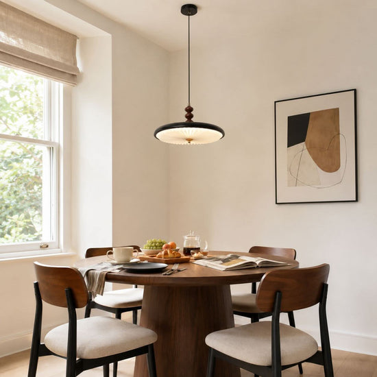 black pleated pendant light over a kitchen island