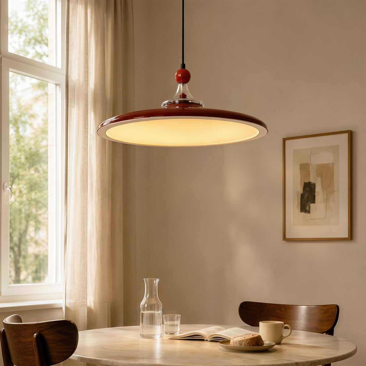 red iron pendant light hung above a dining table