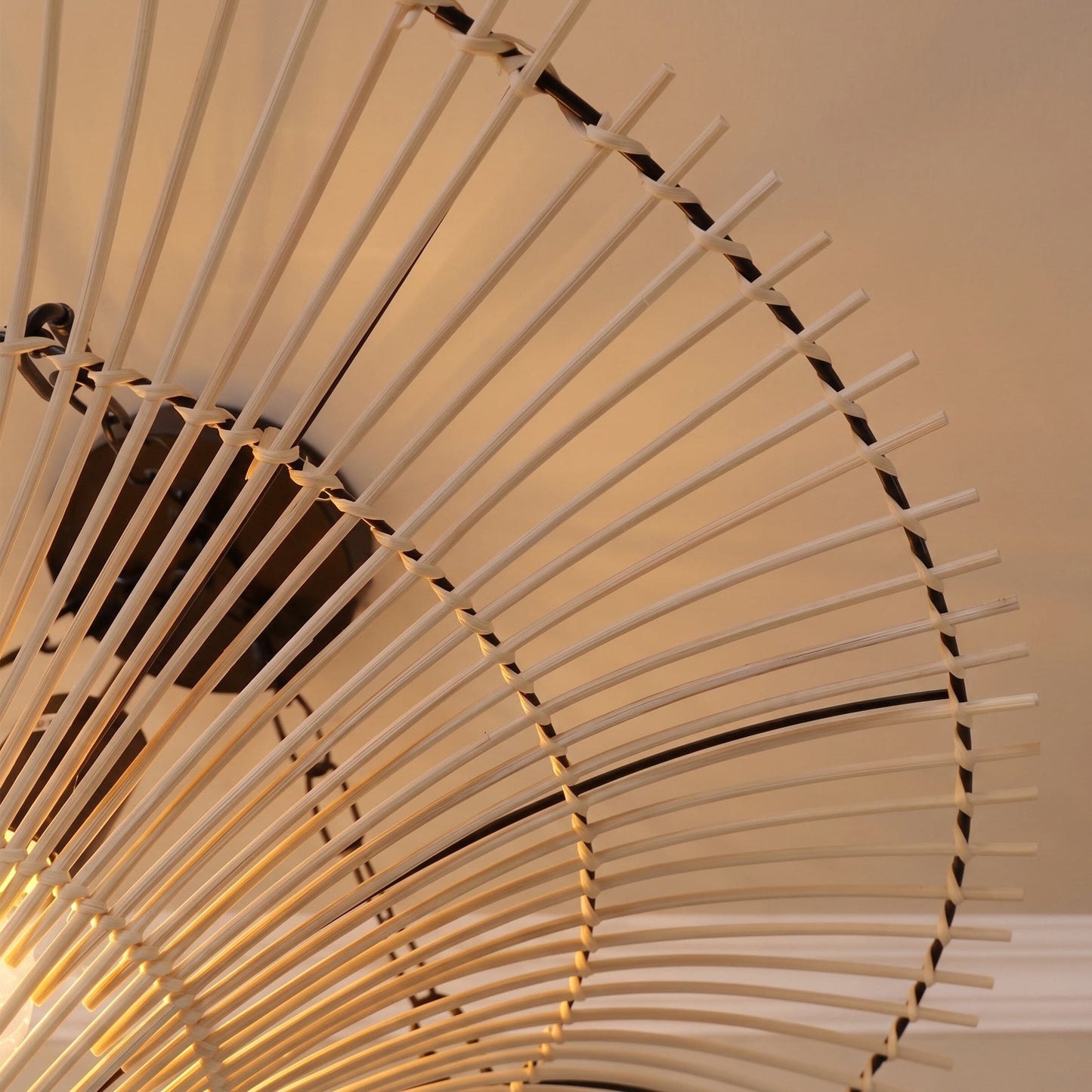 Close-up of the handwoven rattan shade ribs on a flying saucer ceiling light