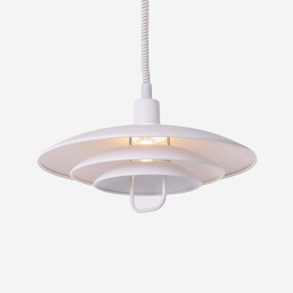 white layered minimalist pendant light styled in a calm bedroom
