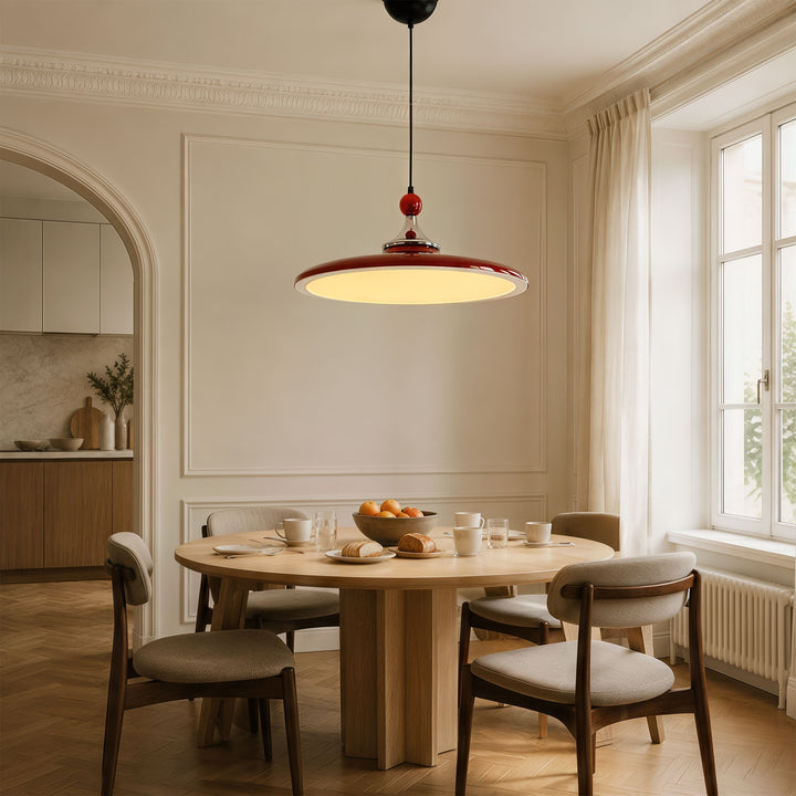 red iron pendant light styled in a calm bedroom