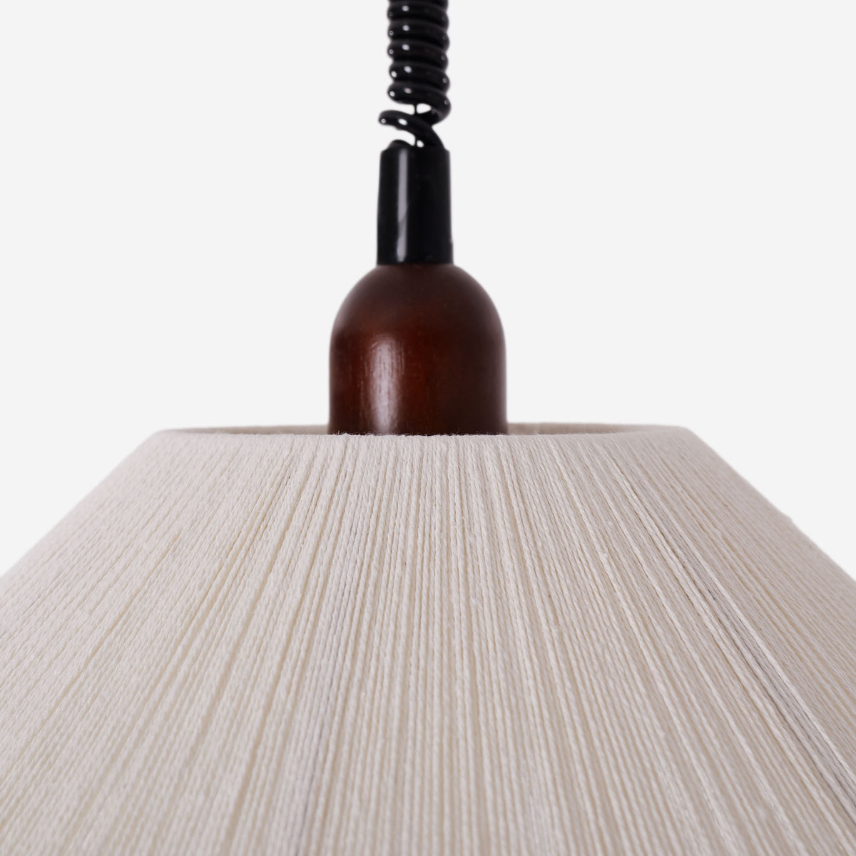natural wood curved pendant light adding warm light to a dining space