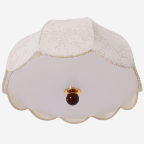 yellow fabric pendant light styled in a calm bedroom