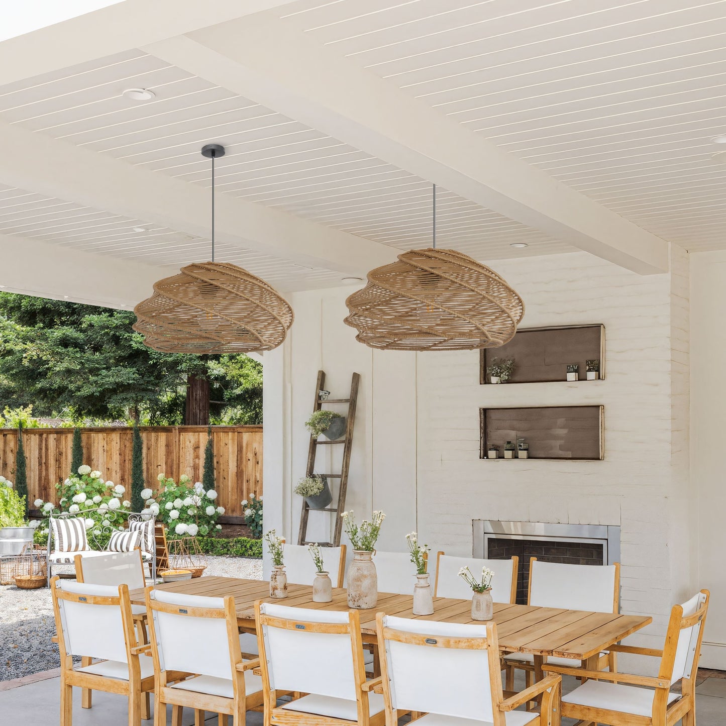 pair of woven rattan pendant lights over a dining table in an airy home