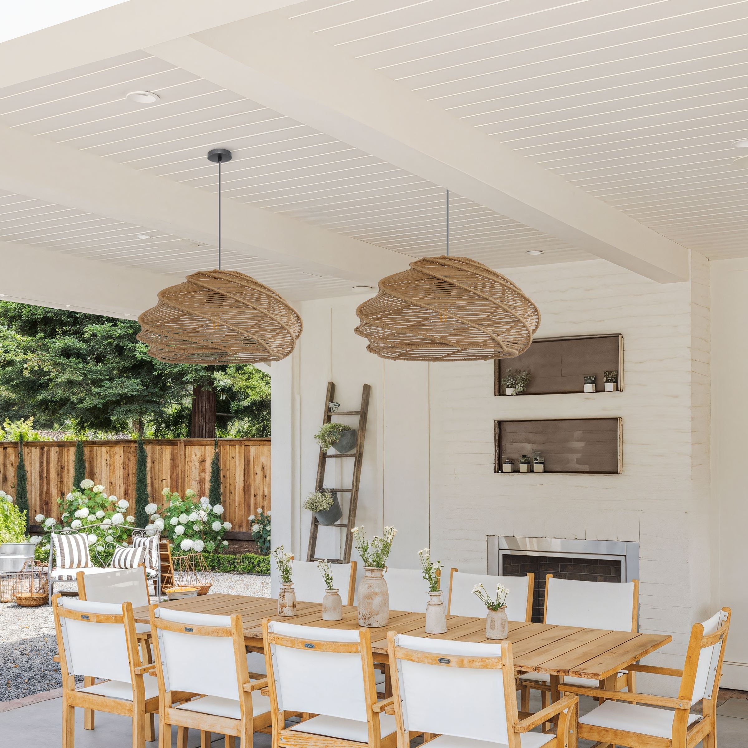 pair of woven rattan pendant lights over a dining table in an airy home