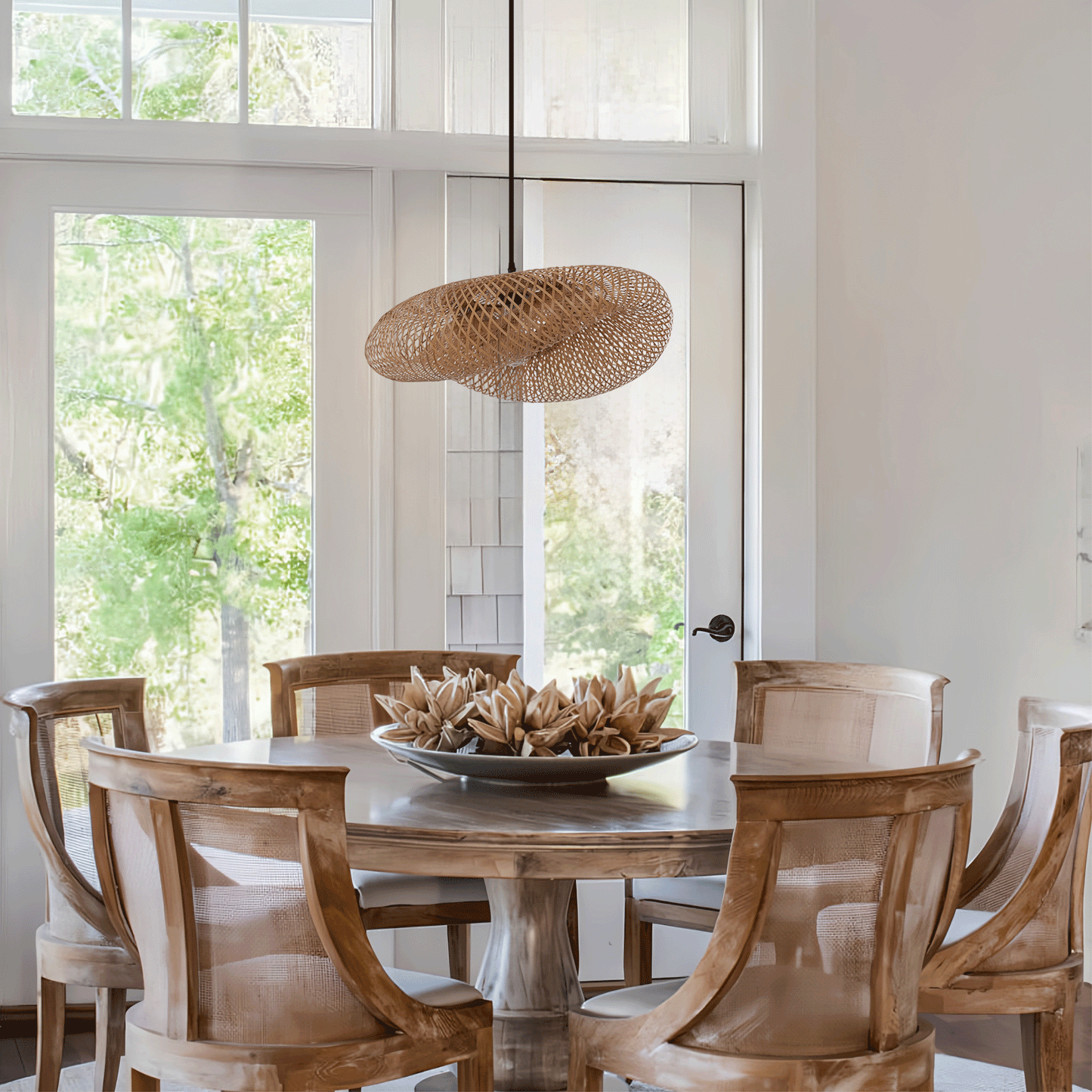 natural bamboo pendant light over a round dining table with garden view