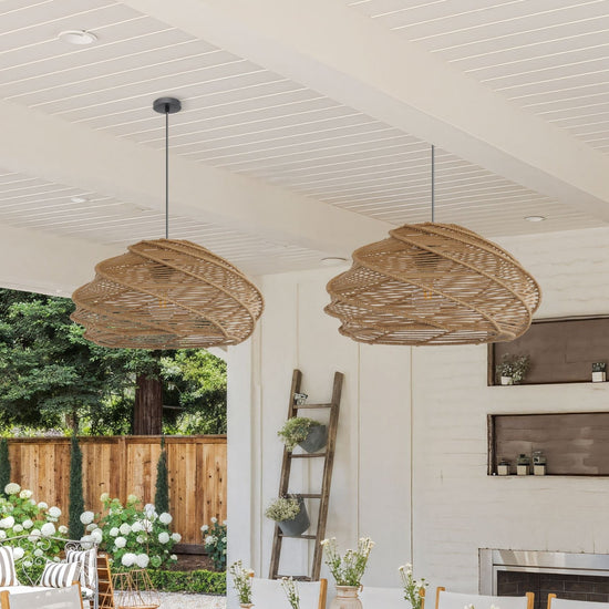two spiral rattan pendant lights above a bright dining table with garden view