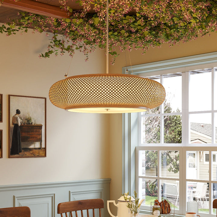 bamboo pendant light above a dining table by a window