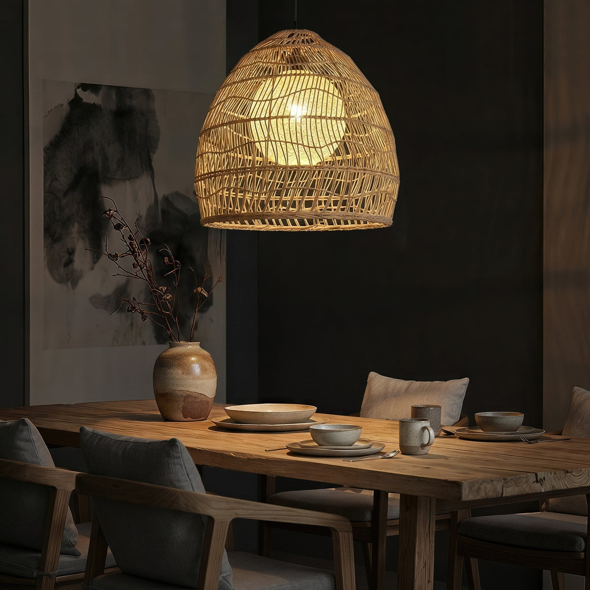 Rattan pendant light with inner sphere above a dark restaurant table