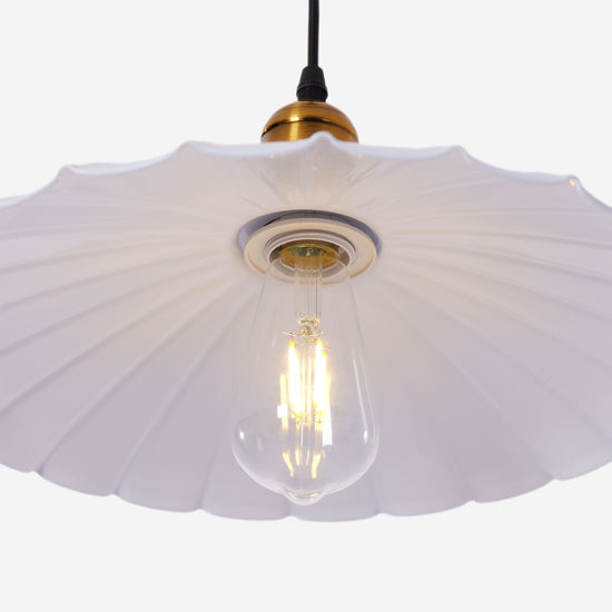 white iron pendant light styled in a calm bedroom
