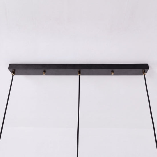 3-light walnut wood mini pendant beside a cosy seating area