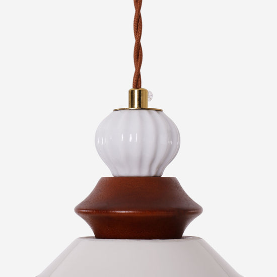 brown ceramic lace pendant light adding warm light to a dining space