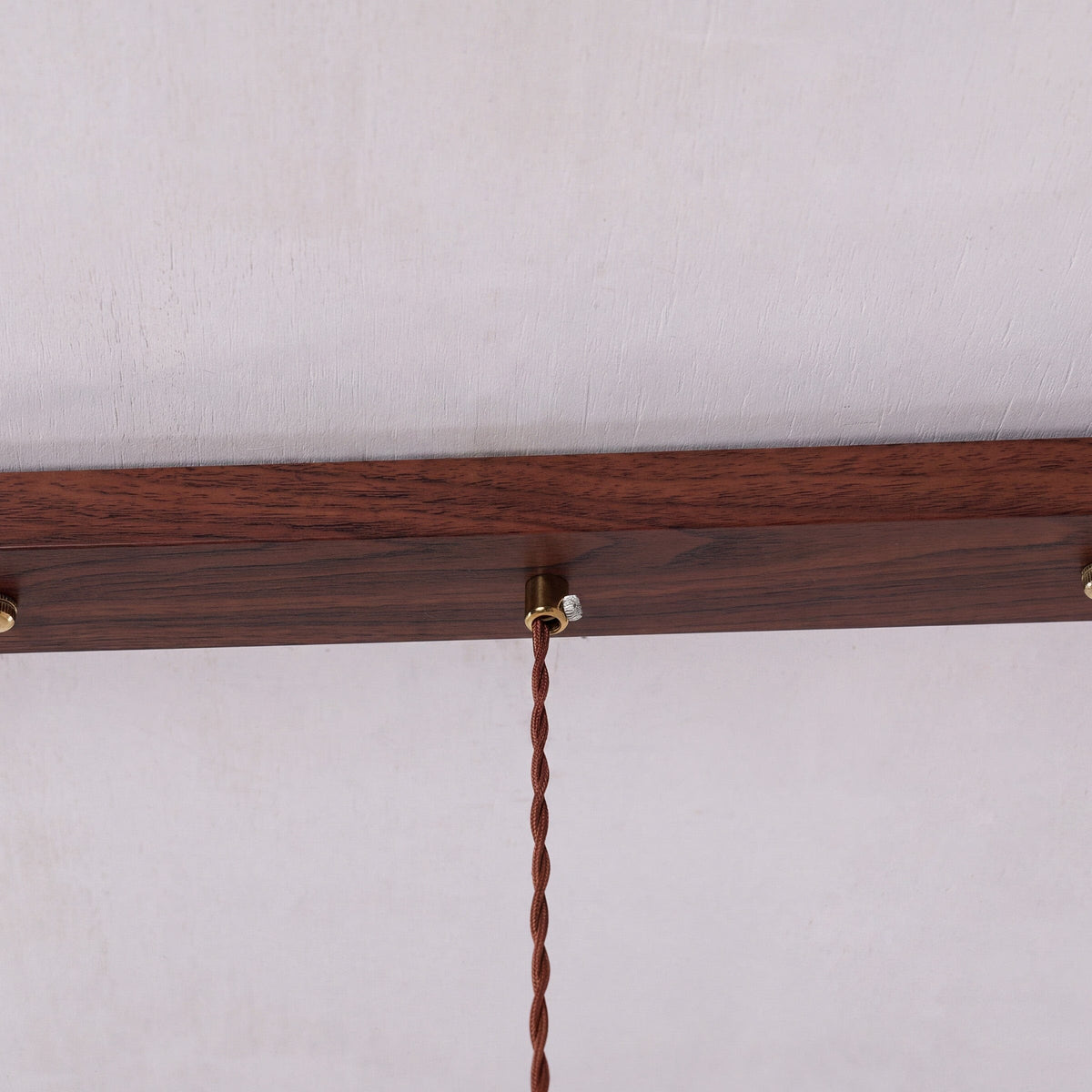 3-light walnut resin mini pendant adding warm light to a dining space