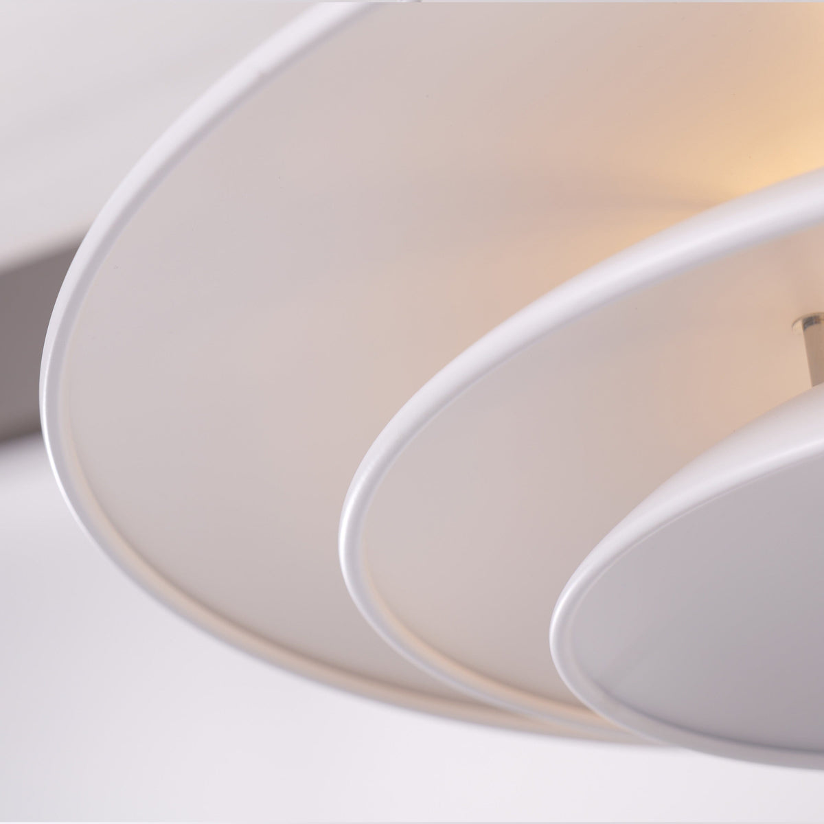 white layered minimalist pendant light adding warm light to a dining space