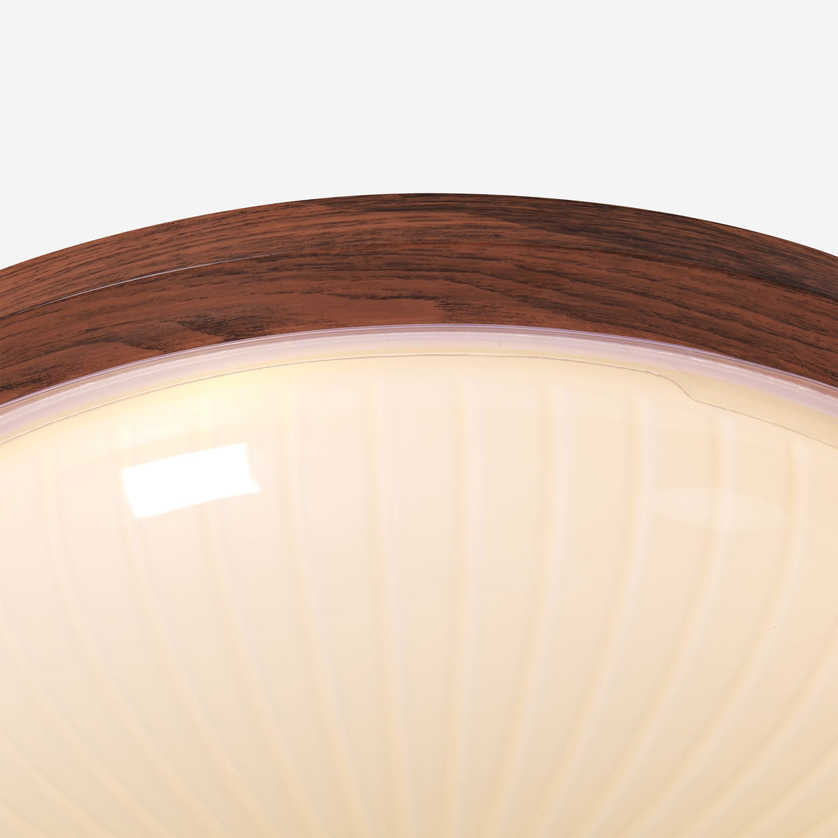 walnut ribbed acrylic ceiling light adding warm light to a bedroom