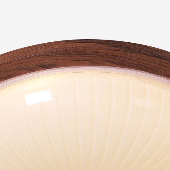 walnut ribbed acrylic ceiling light adding warm light to a bedroom