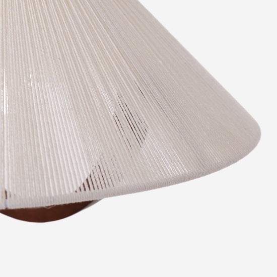 natural wood curved pendant light hung above a dining table