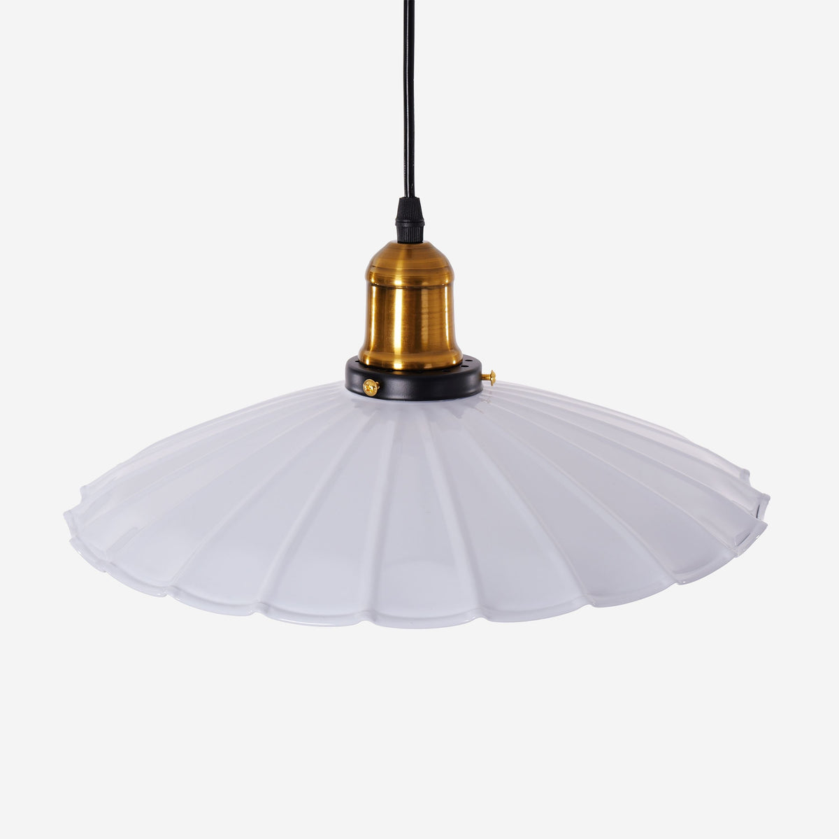 white iron pendant light adding warm light to a dining space