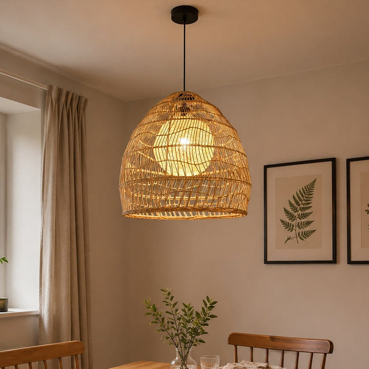 Rattan pendant light with yellow inner sphere above a warm dining table