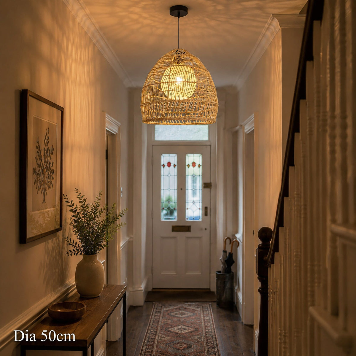 50cm rattan pendant light with yellow inner sphere glowing in a hallway