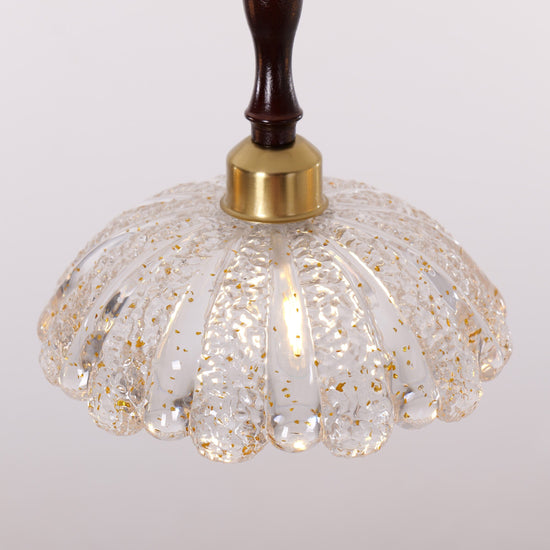 3-light walnut resin mini pendant hung above a dining table