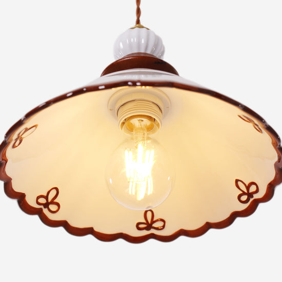 brown ceramic lace pendant light styled in a calm bedroom