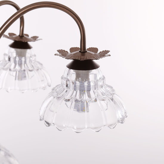 gold 6-light floral glass chandelier in an elegant lounge setting