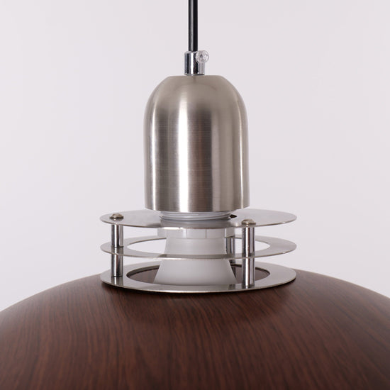 3-light walnut iron bar pendant hung above a dining table