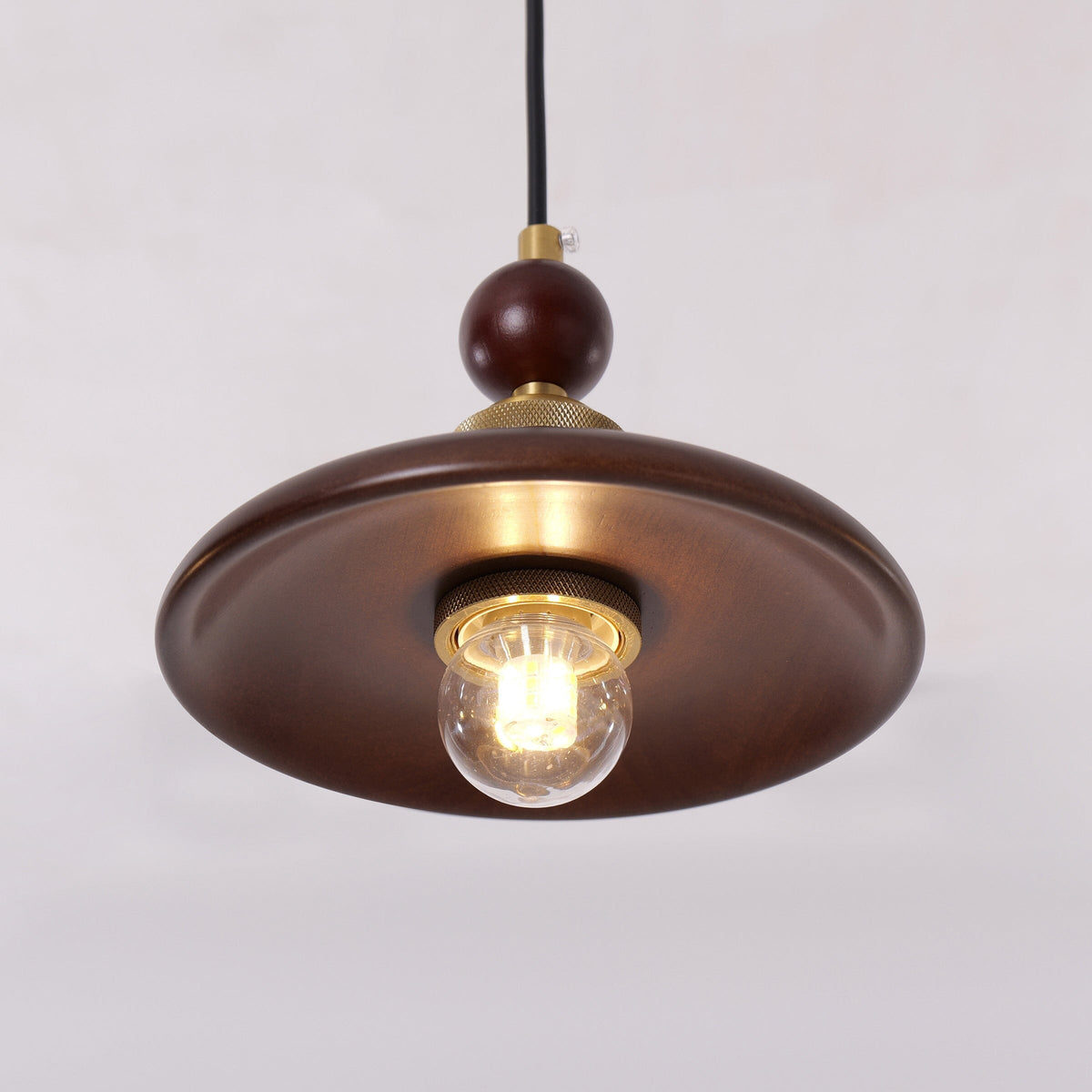 3-light walnut wood mini pendant over a kitchen island