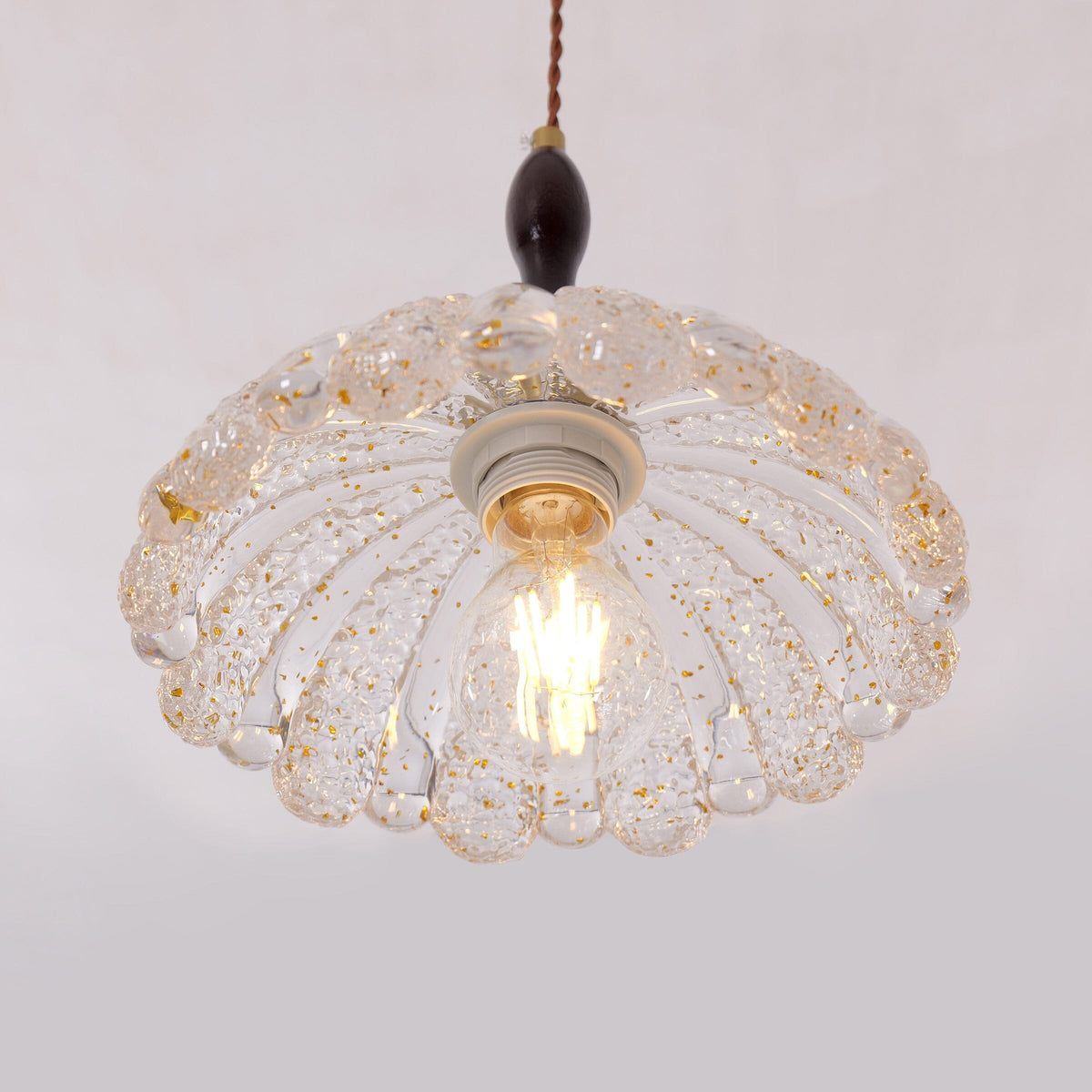 3-light walnut resin mini pendant over a kitchen island