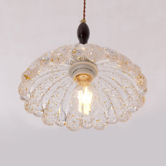 3-light walnut resin mini pendant over a kitchen island