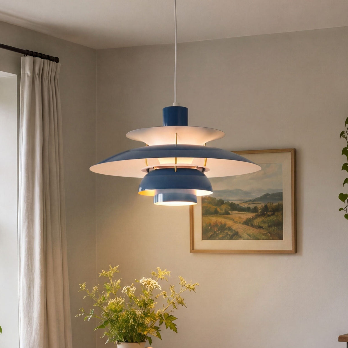 blue layered minimalist pendant light hung above a dining table