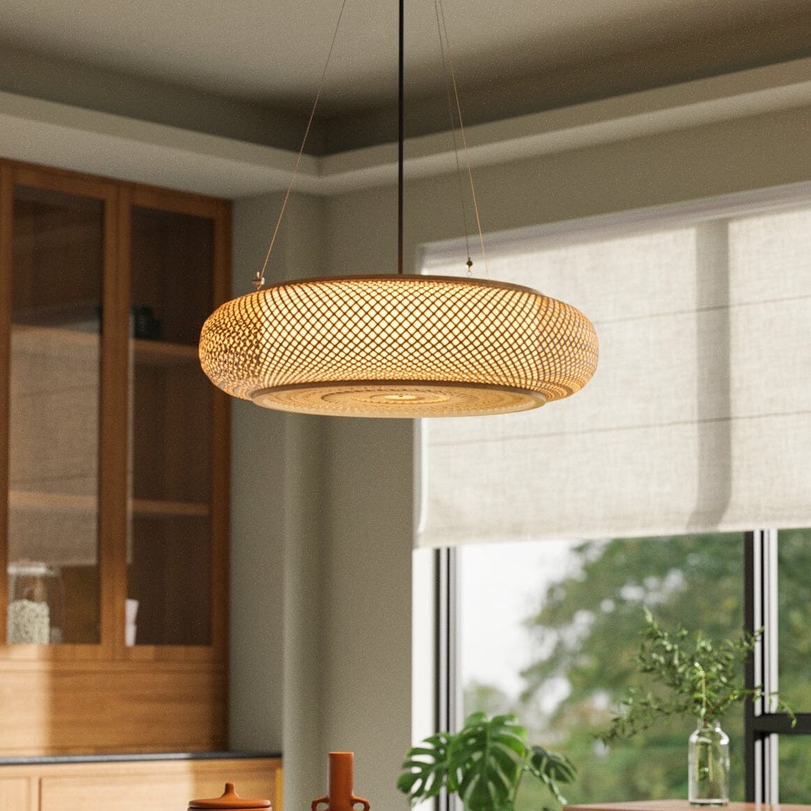 large bamboo pendant light above a round dining table