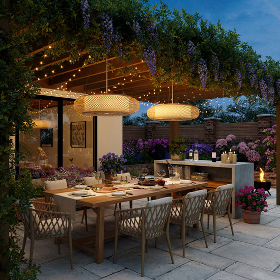 pair of bamboo pendant lights in an evening garden dining area