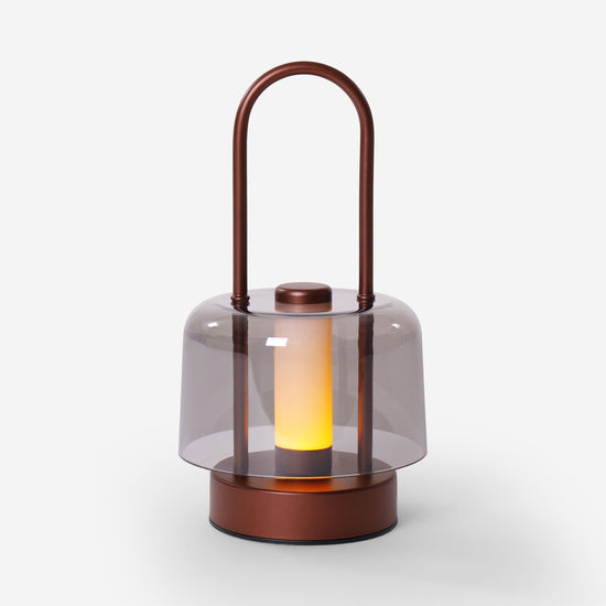 portable lantern-style ambient table lamp beside books and evening decor