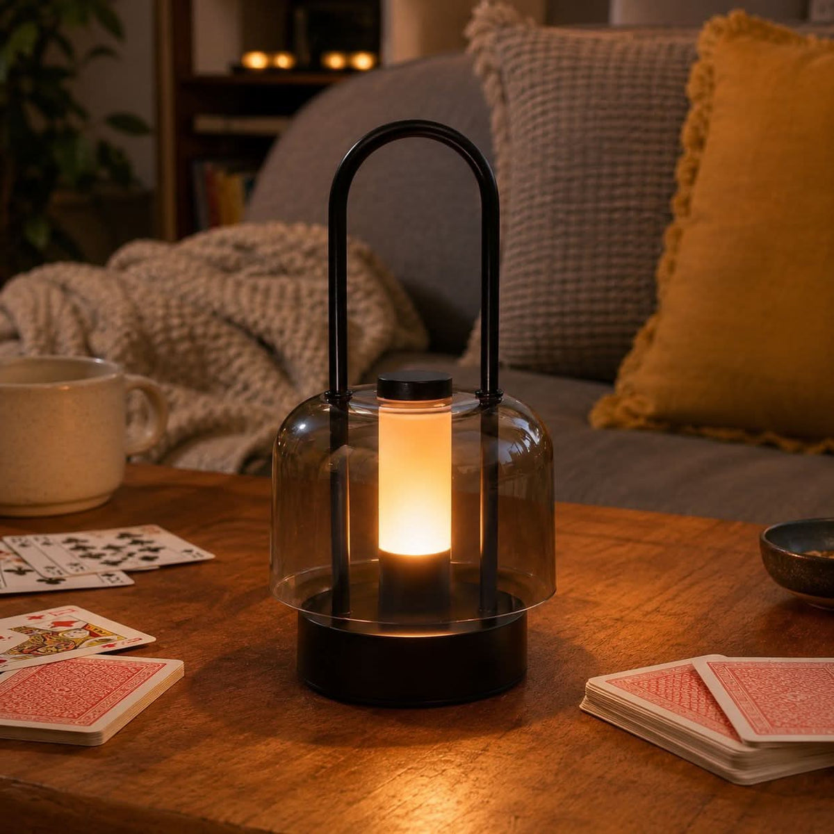 portable lantern-style ambient table lamp adding warm light to a bedroom