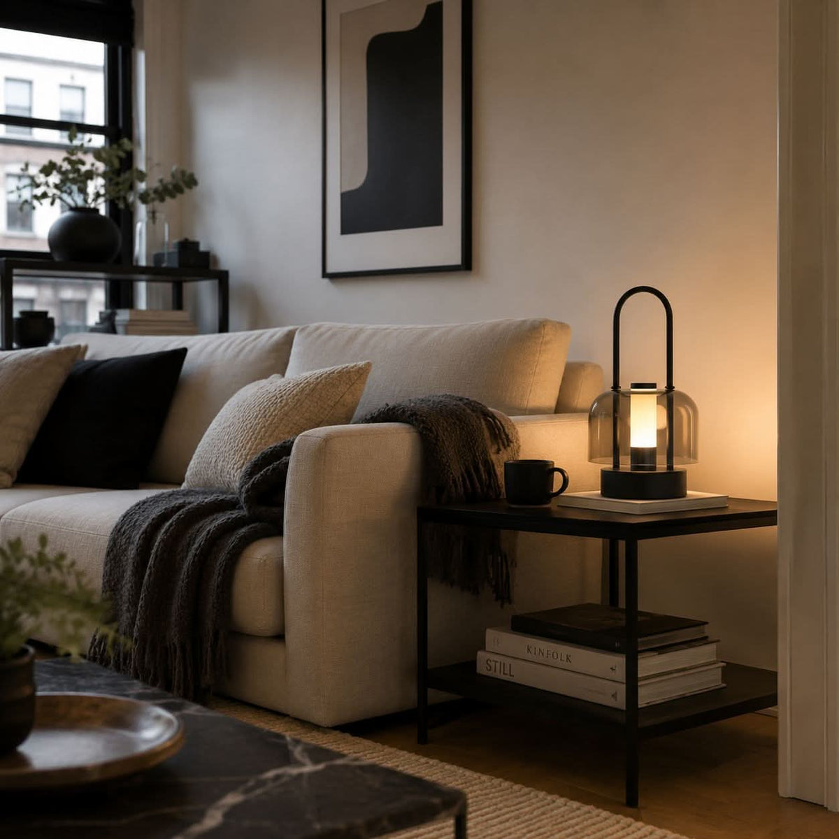 portable lantern-style ambient table lamp adding warm light to a bedroom