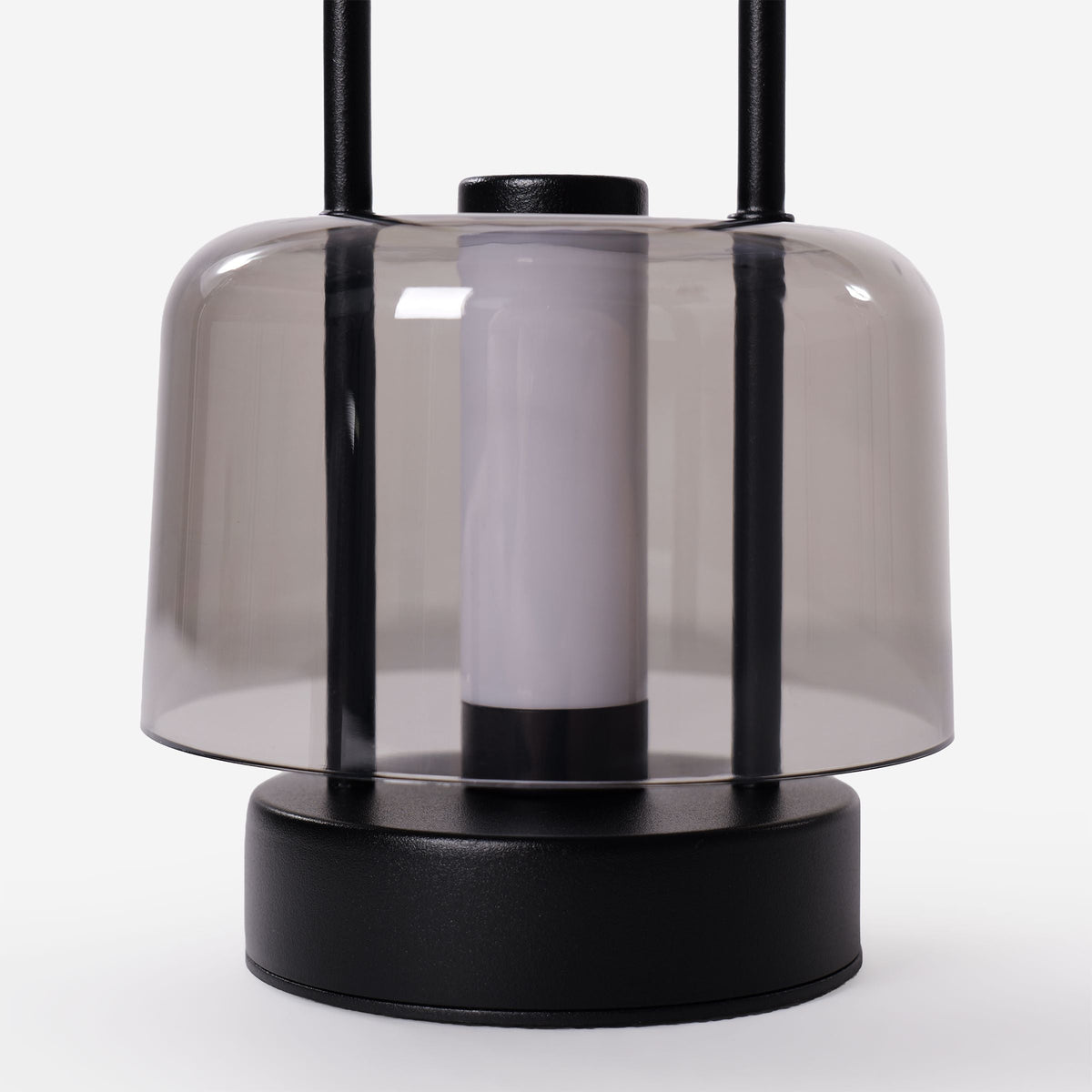 portable lantern-style ambient table lamp on a desk with soft ambient light