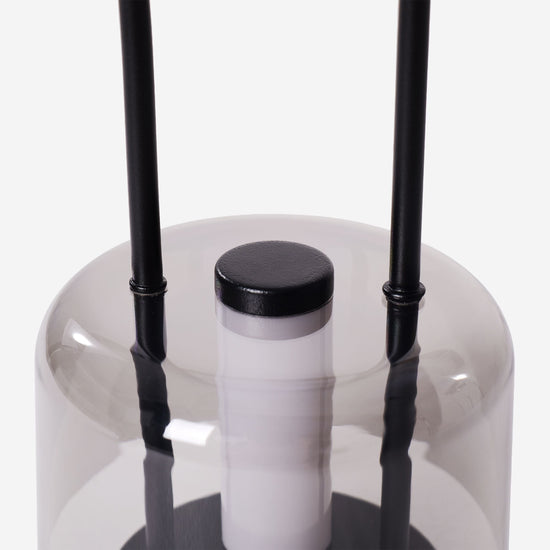 portable lantern-style ambient table lamp adding warm light to a bedroom