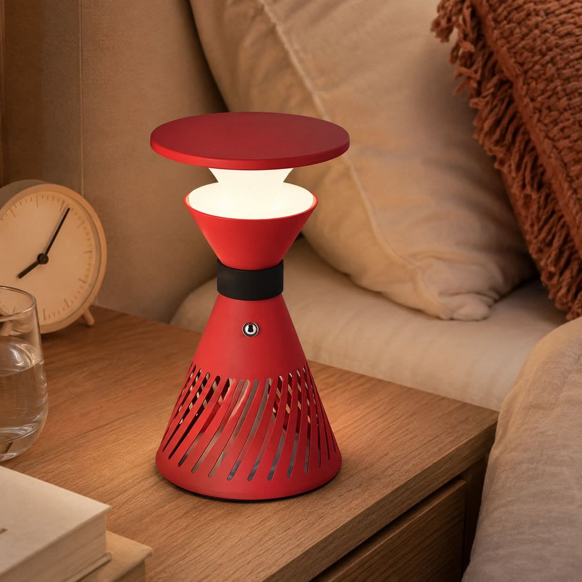 retro funnel cordless table lamp glowing on a bedside table