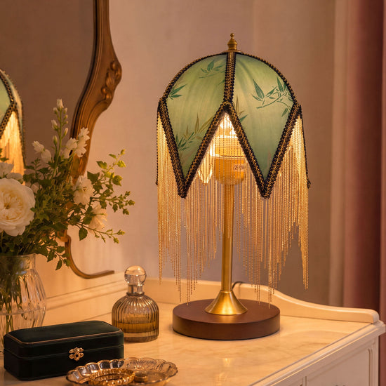 mid-century tassel table lamp glowing on a bedside table