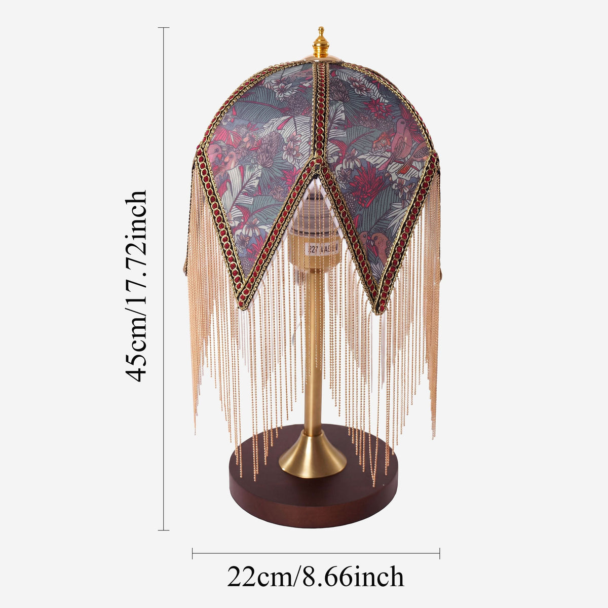 mid-century tassel table lamp beside books and evening decor